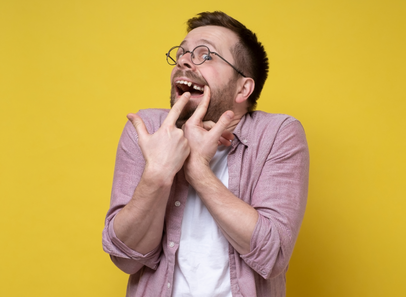 Man pointing at missing tooth
